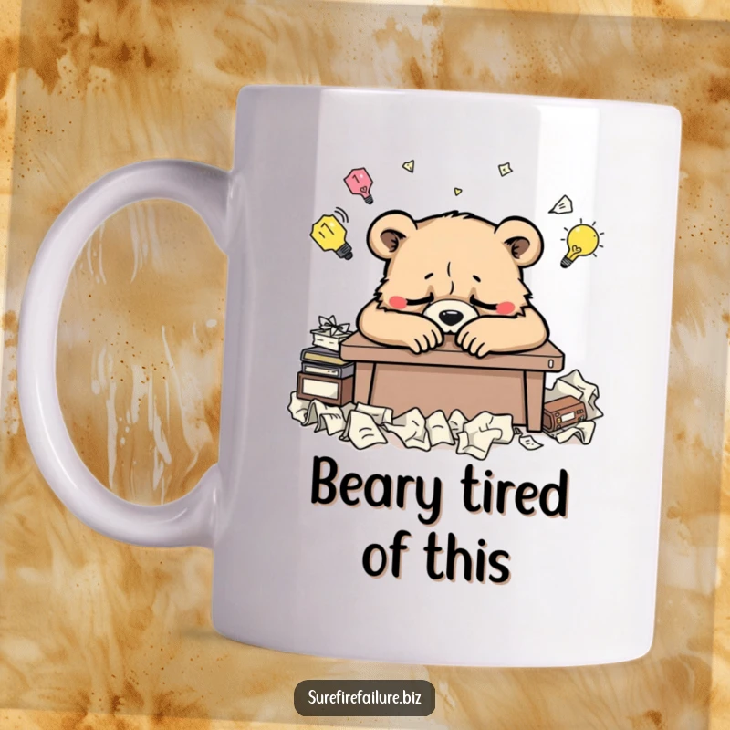 Funny bear mug with a weary animal slumped over a desk surrounded by crumpled ideas, capturing creative burnout humor