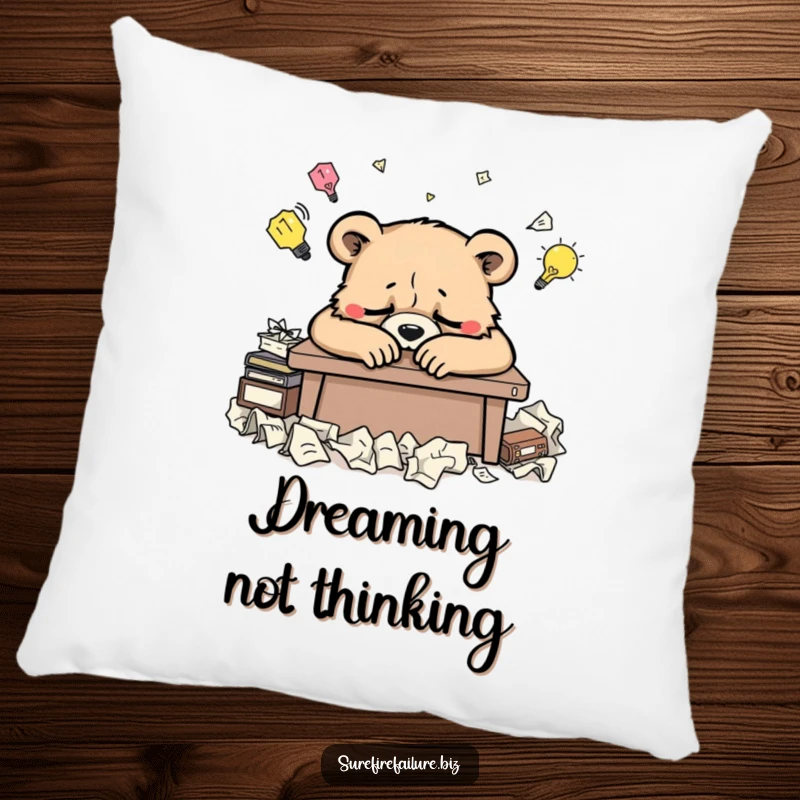 Funny bear desk pillow featuring a weary animal slumped over a desk and crumpled ideas, perfect for humorous comfort