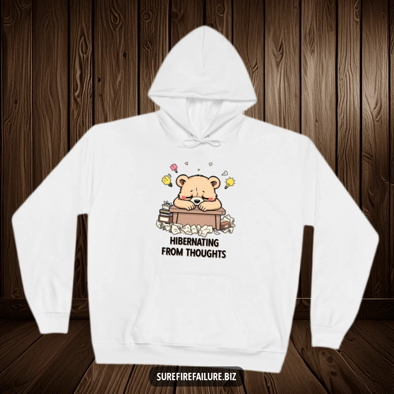 Funny bear hoodie showing a weary animal slumped over a desk surrounded by crumpled ideas, perfect for cozy creative vibes