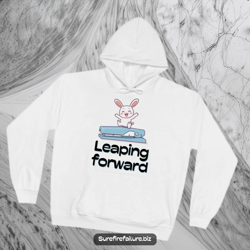 Funny bunny hopping joyfully over a broken stapler on a warm hoodie, a cozy and humorous piece of apparel.